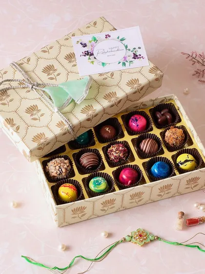 Illuminate your bond with sweetness. This beautiful box of our assorted artisanal chocolate bonbons makes for a perfect and elegant Rakhi gift.