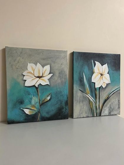 A set of two floral paintings on canvas, showcasing a textured background and clean, elegant flowers. These make for beautiful home decor pieces.