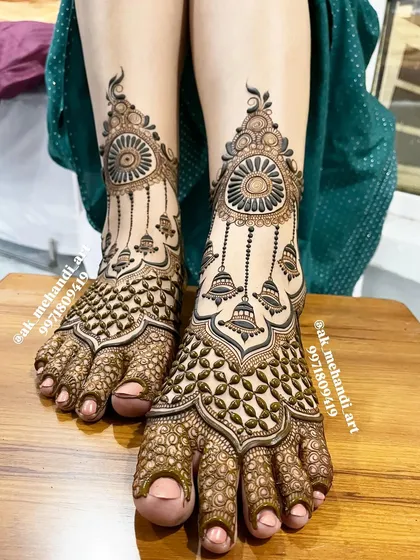 Bridal mehndi isn't complete without beautiful feet. This design features intricate jaali work on the toes and a central motif with delicate hanging bells, ensuring you look perfect from head to toe.