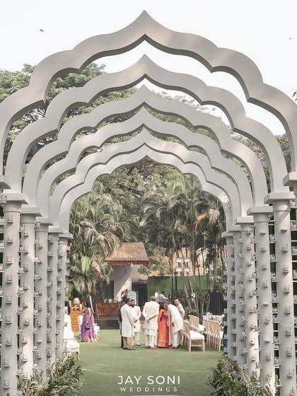 A closer look through the repeating arches of the all-white walkway, creating a stunning tunnel effect that draws the eye forward and builds excitement for what lies beyond.