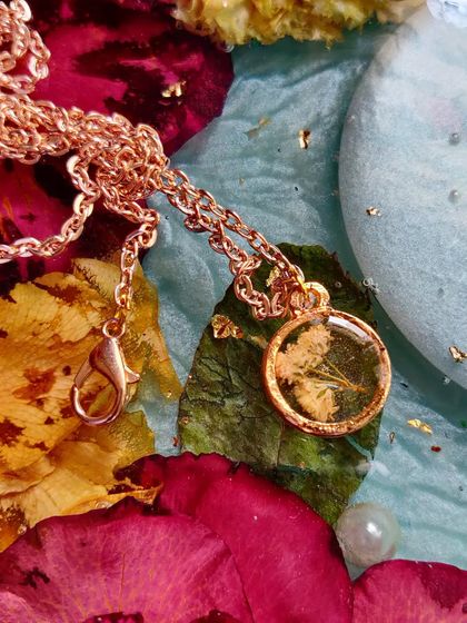 Even the tiniest flowers can be preserved. This mini pendant features a delicate baby's breath flower set in clear resin with a rose gold chain.
