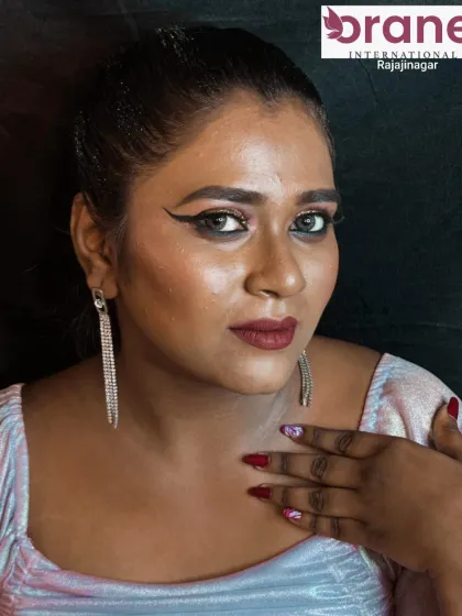 This shot shows the complete look with statement earrings and matching nails, perfect for a glam photoshoot.