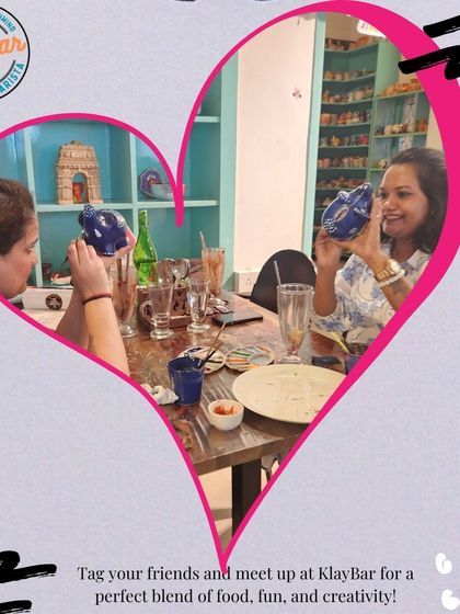 Two friends proudly showing off the piggy banks they've painted. Our activities are great for unleashing your group's creative side.