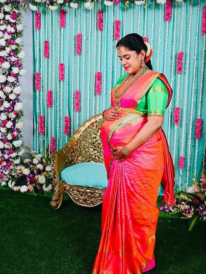 The bright, happy colors of this Kanchipuram silk saree are perfect for celebrating the upcoming arrival of a new family member.