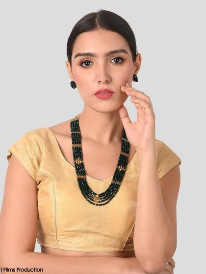 A model shot focused on a multi-layered beaded necklace and matching earrings. We ensure the jewelry is the focal point, with clean lighting that captures its sparkle and detail.