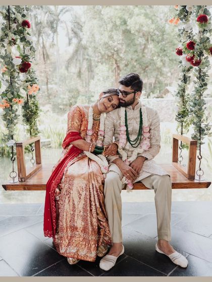 A moment of quiet rest on a swing after the ceremony. The bride leans on her groom's shoulder, a picture of comfort and love.