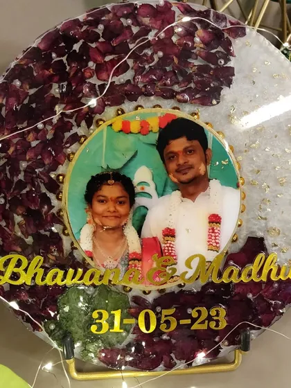 Here is a beautiful circular resin frame preserving a couple's varmala flowers. I added their photo, names, and wedding date to make it a truly personal piece of decor for their home.