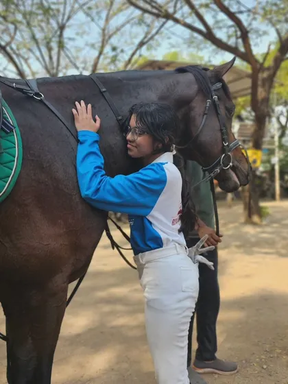 A rider shares a hug with her equine partner. These moments of affection are a daily sight at our academy and are a huge part of the joy of riding.