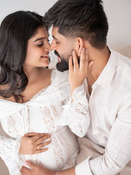 A sweet and playful moment captured during a maternity session. The genuine smiles are what make these photos so special.