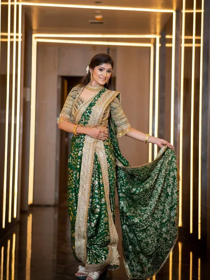 A full-length shot showing the grandeur of the green Nauvari saree. The makeup is designed to be timeless, complementing the traditional draping style.