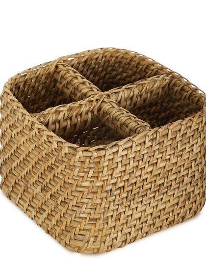 This woven cutlery holder is divided into four compartments, making it perfect for organizing utensils on a dining table or kitchen counter. Its natural texture adds a rustic touch to your home.
