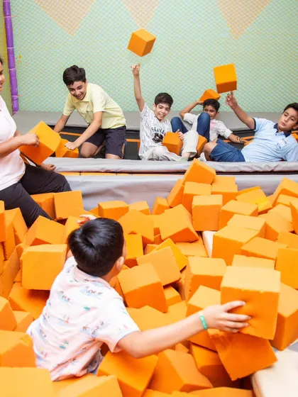 Friends are what make celebrations the best! A group of boys having a blast in the foam pit.