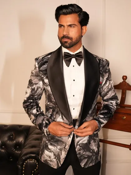 The Concerto Tuxedo features a dramatic black and white abstract pattern, perfect for the gentleman who wants to express his artistic side. The satin shawl lapel adds a touch of classic formality.