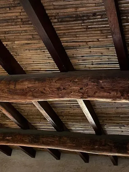 A close-up of the ceiling at the Hassan farmhouse, showing the beautiful texture created by combining large timber beams and split bamboo.