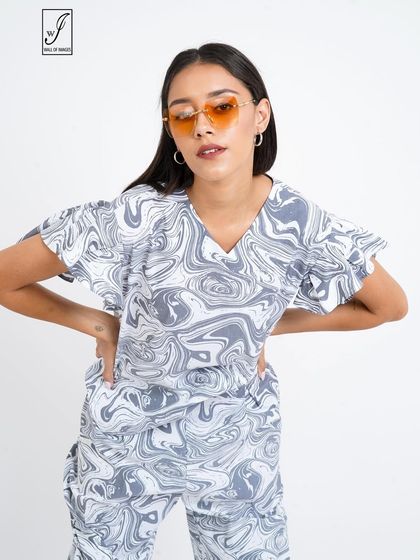 A close-up on a marble-print co-ord set, showing the pattern and the model's trendy sunglasses.