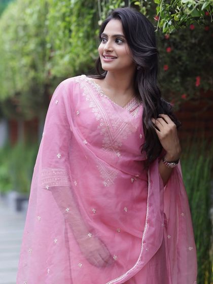 A beautiful portrait in an outdoor setting. The natural light enhances the soft, glowing makeup.