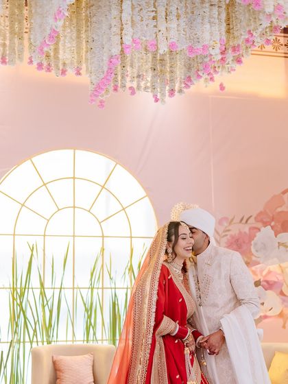 A candid shot of the couple sharing a laugh during their wedding ceremony, capturing their easy chemistry.