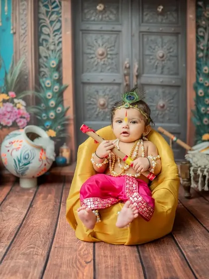 This little Krishna, dressed in pink and yellow, looks adorable in the yellow beanbag chair.