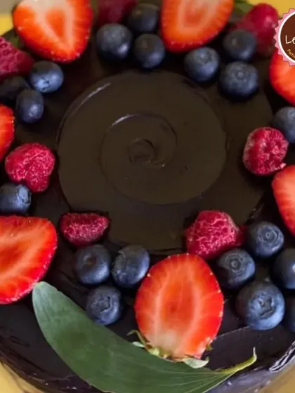 A close-up of my Choco Berry Gateaux. The rich, dark chocolate top is beautifully decorated with a ring of fresh strawberries, blueberries, and raspberries.