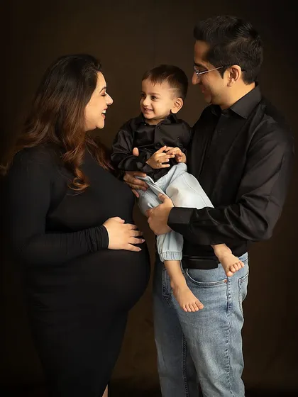 An interactive family portrait where the parents and son share a laugh. This shows that classic portraits can be full of life and personality.
