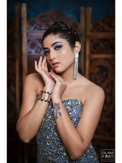A stunning party look created by one of our talented students. The purple winged eyeshadow and embellished hair create a unique and glamorous style.