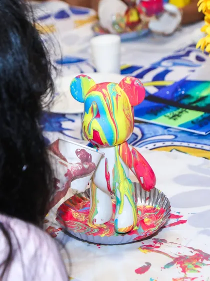 A close-up of a completed fluid bear, showcasing the vibrant and unique patterns created by the guest.