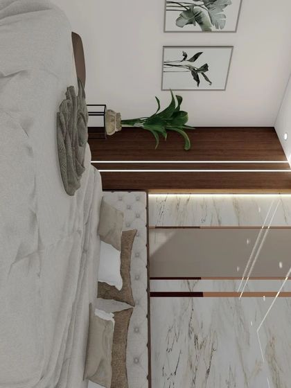 A view from the foot of the bed, highlighting the tufted headboard and the elegant wardrobe with marble and rose gold inlay details.