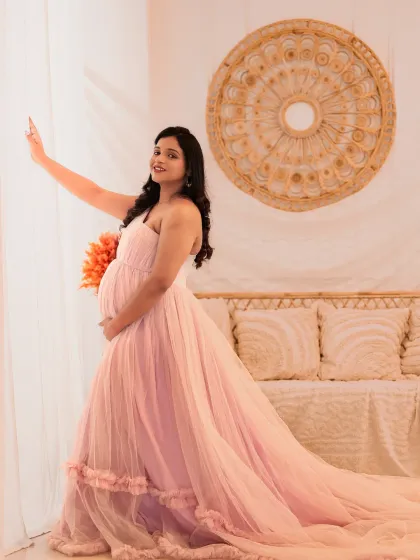 A soft and romantic portrait in our boho-chic setup. The light pink gown with its long train looks beautiful against the natural textures of the rattan furniture and light curtains.