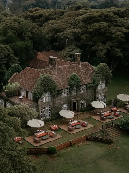 An aerial drone shot of the stunning Giraffe Manor in Kenya. This image establishes the incredible sense of place and the unique, exclusive atmosphere of Monica and Nate's destination wedding.