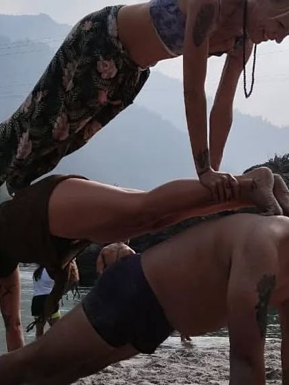 A different angle of the three-person plank. You can see the concentration and effort it takes to hold this pose.