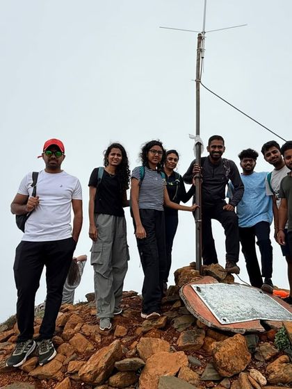 A group photo at the Kudremukha peak marker. Reaching this point is a proud moment for every trekker.