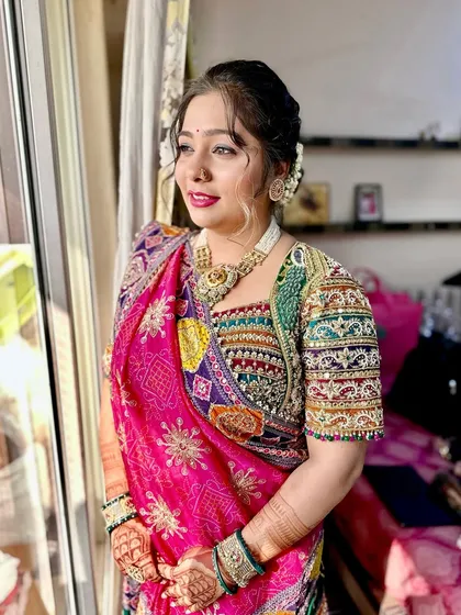 Another angle of this beautiful, sun-kissed look, showing how the makeup enhances her features and complements her colorful traditional outfit.