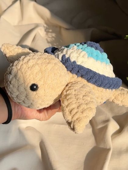 This is one of our large, chunky yarn turtles. The shell features a beautiful blue gradient, making it a unique and artistic piece.