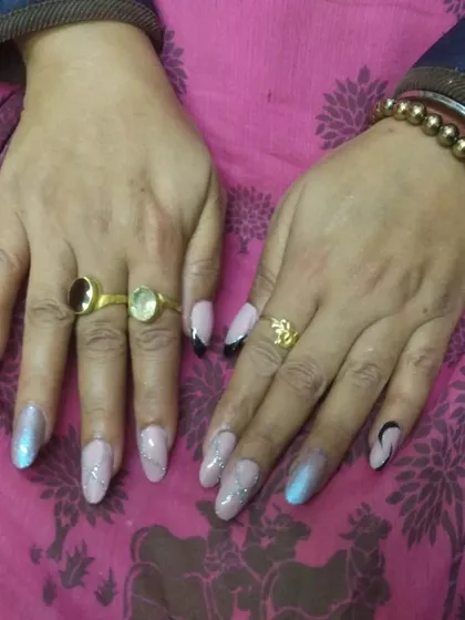 A full view of this chrome and glitter nail set. The mix of different textures and colors creates a unique design that is both stylish and eye-catching.