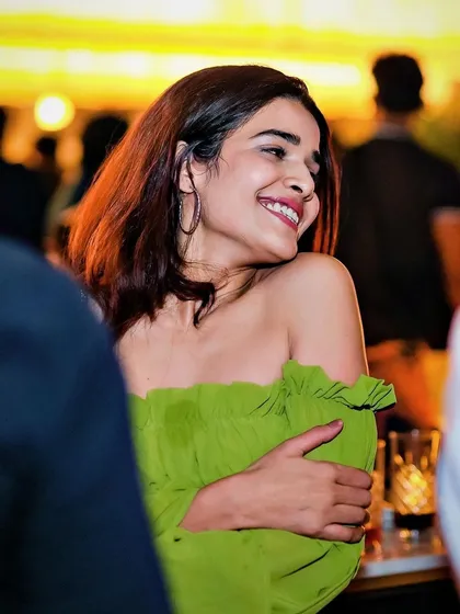 A candid shot of a guest smiling and enjoying the music.