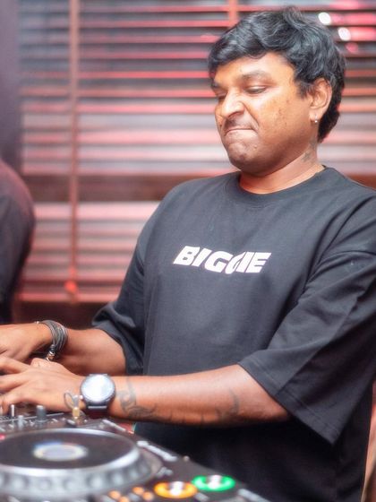 A close-up shot of me working the mixer. Every knob and fader plays a part in crafting the perfect sound journey for the dance floor.