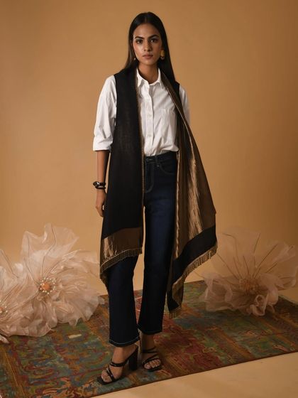 Here, I styled a classic white shirt and jeans with a long, metallic-accented vest. This shows how a single heritage piece can be used to elevate a simple, everyday outfit into a chic, indo-western look.