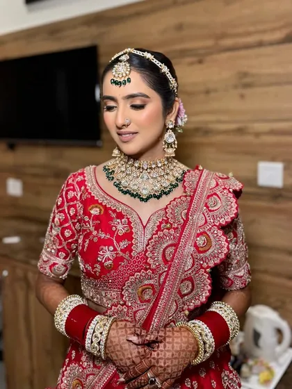 Simran looking serene and beautiful before her ceremony. The makeup was designed to be timeless, with a focus on flawless skin and soft contouring to enhance her features.