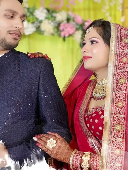 A candid, romantic moment between the couple during their wedding reception, beautifully captured for their album.