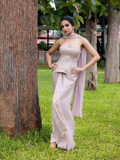 This outfit is perfectly balanced for a cocktail evening. I designed it with a hand-embroidered strapless corset top and a draped pant-sari, creating an effortlessly glamorous and modern silhouette.