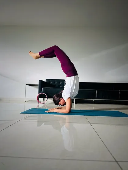 This is Vrschikasana, or Scorpion Pose, on an inversion day. It's an advanced pose that combines a deep backbend with the balance of a forearm stand, requiring strength and openness.