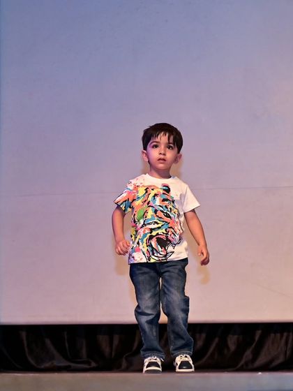 Yuvaan stands confidently on stage, ready to begin his performance.