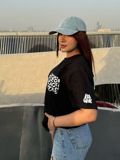 A side profile of the relaxed, oversized tee and jeans look.