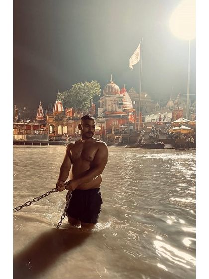Taking a dip in the holy Ganga river at Har Ki Pauri, Haridwar. The chains are there to hold onto against the strong current.