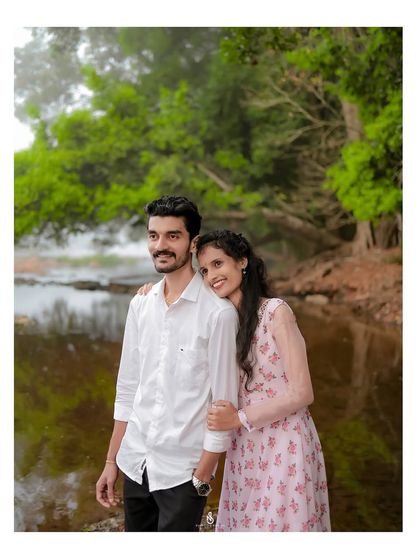 A peaceful moment together, framed by the lush greenery of the riverbank. This composition creates a sense of being in your own private world.