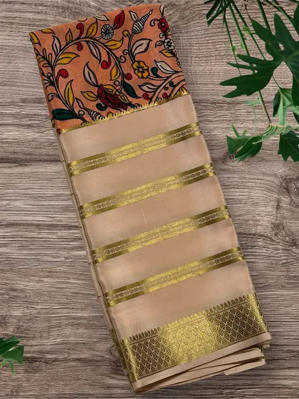 A beautiful pure Mysore crepe silk saree with a floral Kalamkari print on a peach-colored pallu and a beige striped body.