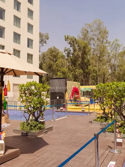 A view of the poolside venue, with quirky decor elements like colorful hanging bottles adding to the festive atmosphere.