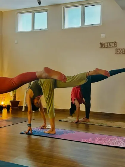 A student holds a variation of Virabhadrasana III (Warrior III), a challenging standing balance that builds strength in the entire body and sharpens focus.