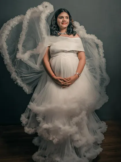 This white ruffled gown comes with detachable "wings" for a dramatic, angelic effect in your studio maternity portraits.