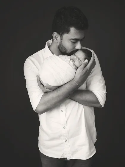 The father and newborn portrait in black and white, emphasizing the emotion and texture of the moment. A truly timeless image.